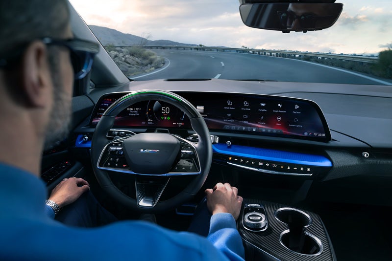 Front View of the 2026 OPTIQ-V Driving Through the Dusk Utilizing its Headlights | Dublin Cadillac in Dublin CA