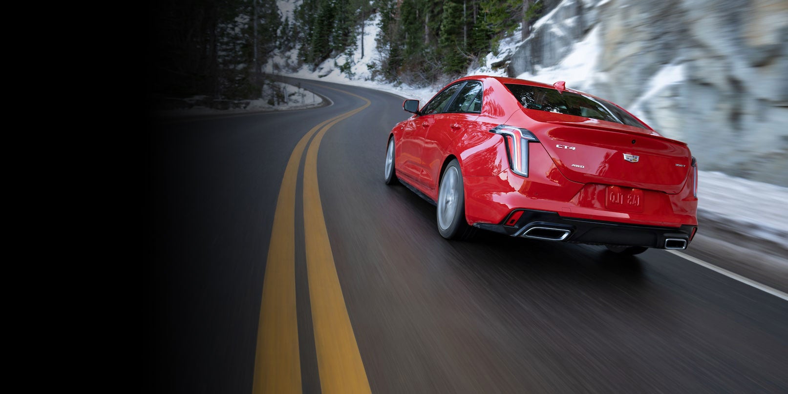 A red car running on the road rear view