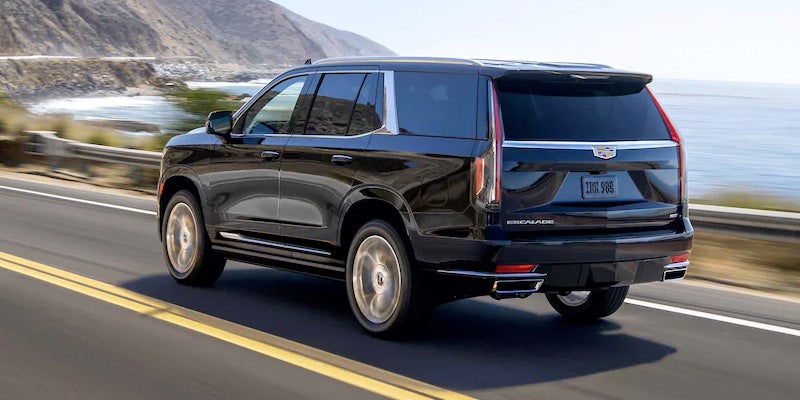A Black SUV running on the road near mountains