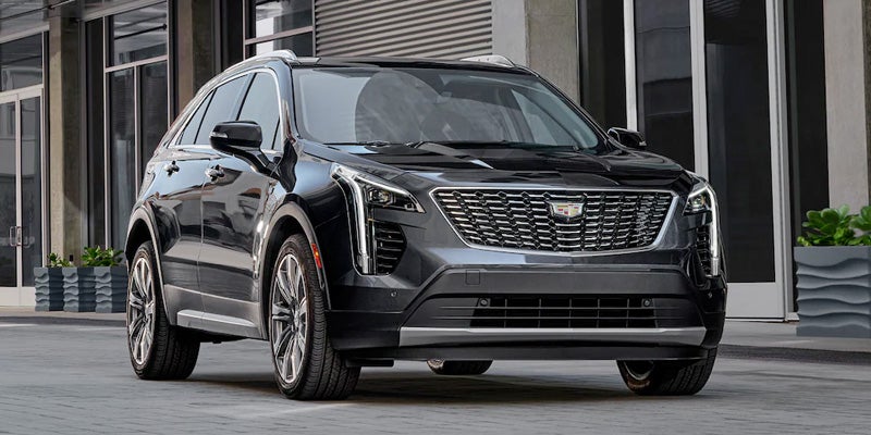 A Cadillac XT4 parked on city road near building