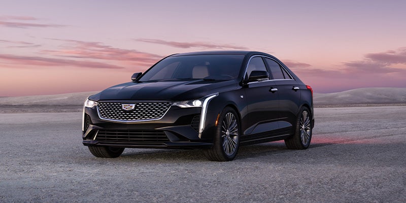 Sleek black Cadillac CT4 sedan at sunset desert backdrop