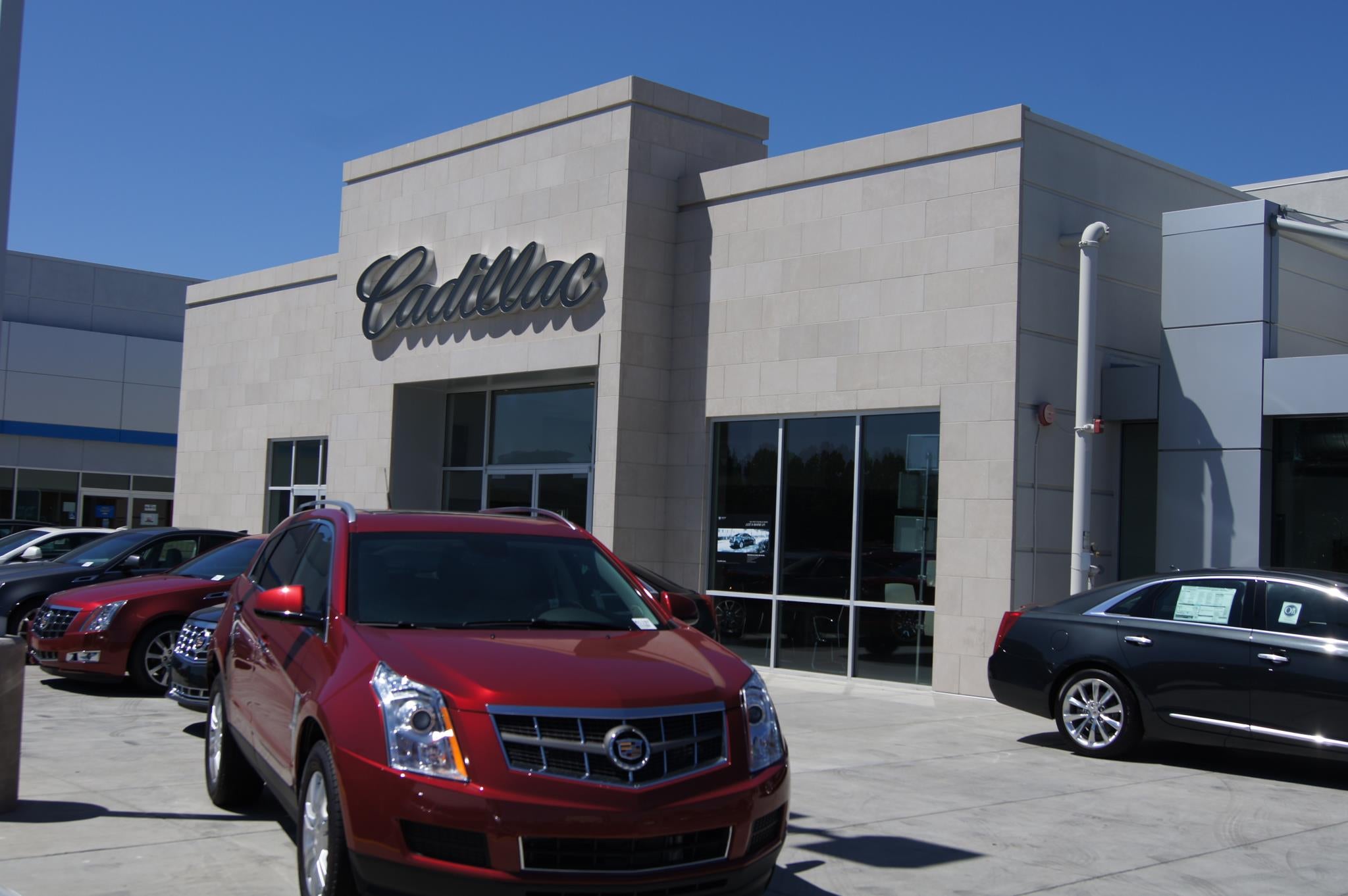 Group of Cadillac Cars in front of Cadillac Building